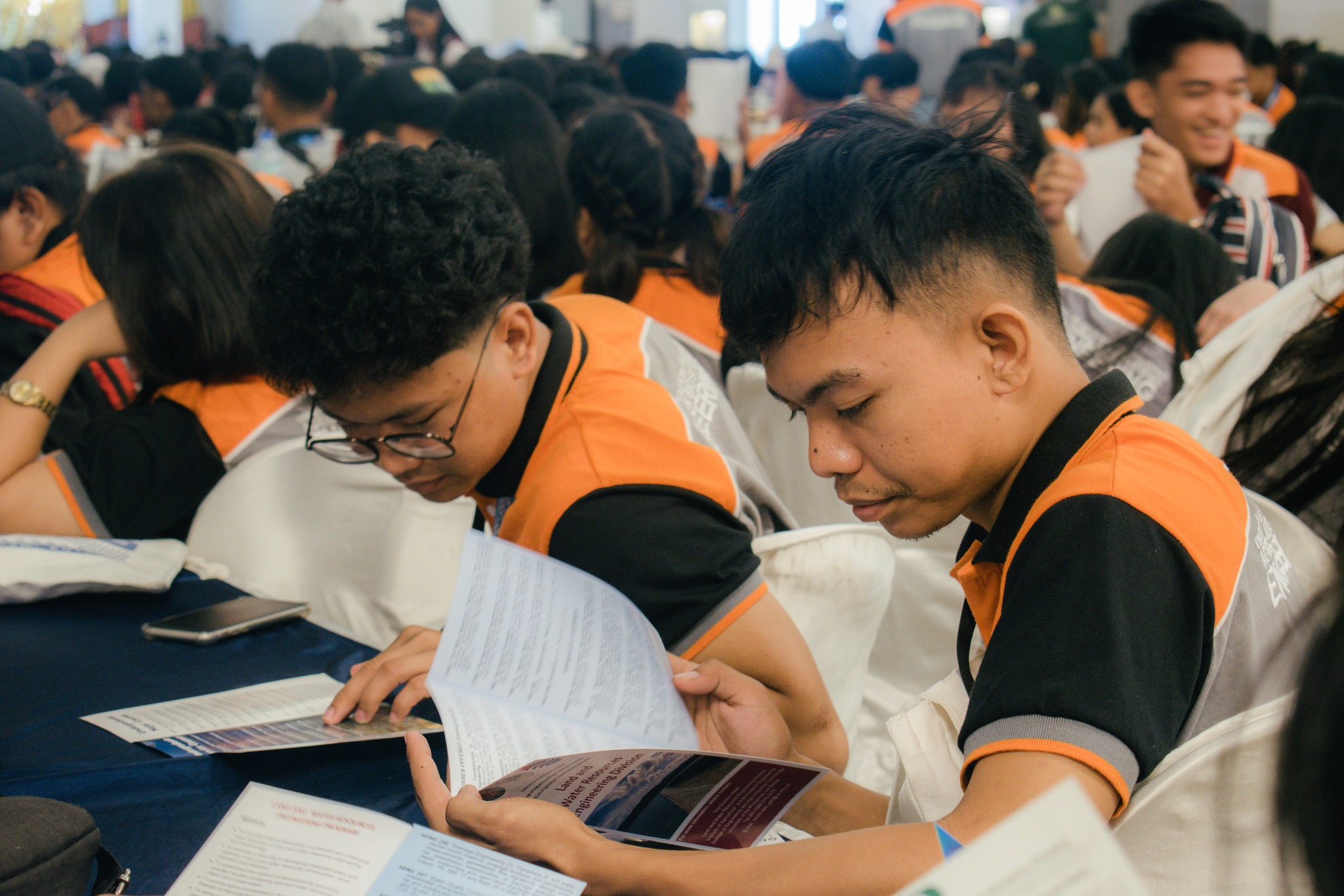 A speaker presenting on stage at the convention